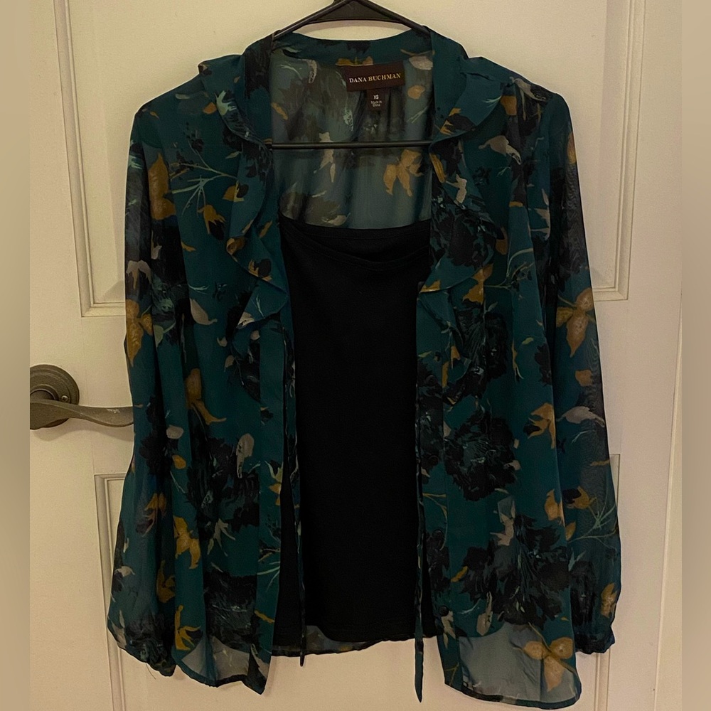 Green see-through top with leaves, with a black tank top. It’s connected.
